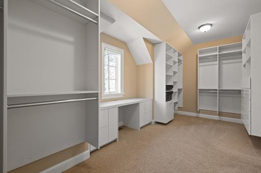 Big walk-in closet filled with custom organization.