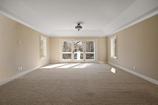 Roomy upper level Primary Suite has a private balcony with a view, enormous walk-in closet filled with custom built-ins, and a luxurious ensuite bathroom!