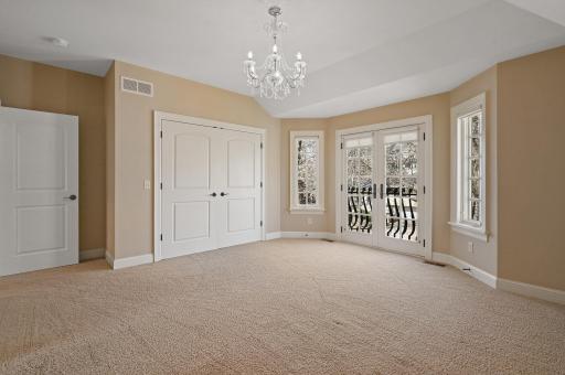 2nd upper level bedroom with glass French doors, stylish chandelier, and access to the full Jack&Jill bathroom.