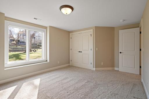 Lower level bedroom with a backyard and creek view!