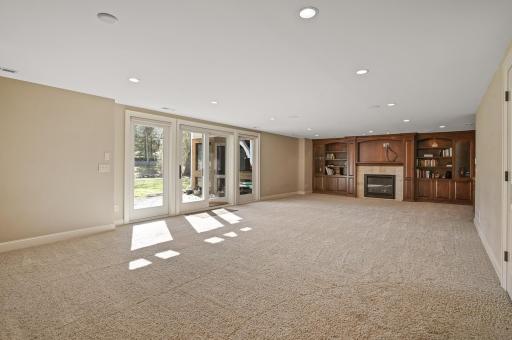 Expansive lower level family room leaves space for a recreation area as well. Includes a beautifully finished wet bar, an abundance of built-ins, and another gas fireplace. Space walks out to the magnificent backyard!