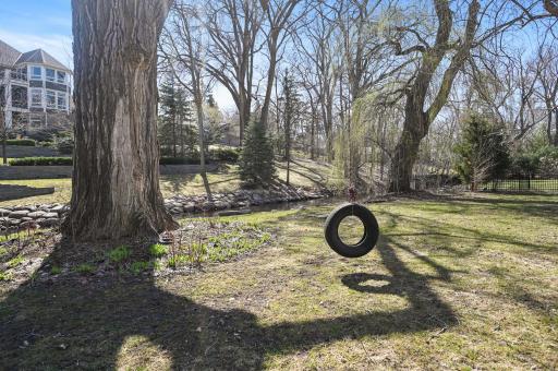 Brand new roof in 2022! Sprawling yard with in-ground irrigation system, a paver patio, and glorious space to run, play, and entertain, all with a peaceful setting along the Minnehaha Creek.