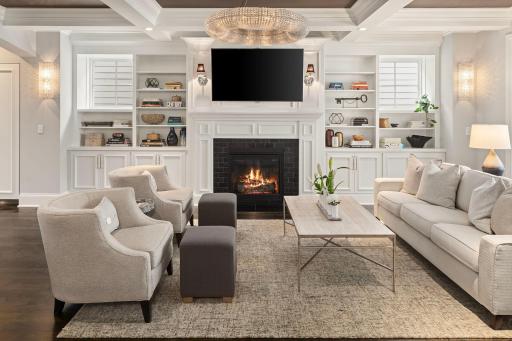 Main level living room with gas fireplace, built-ins, and hardwood floors.