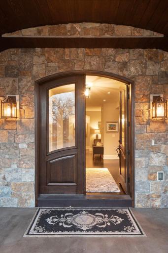 Beautiful arched wood French doors welcome you.