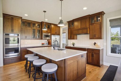 Oversized island with upgraded quartz counters throughout kitchen