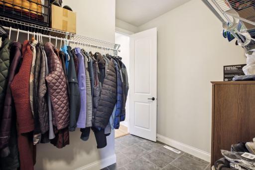 Just one of the many thoughtful custom upgrades in this home...this oversized closet has double doors connecting from the mudroom to the front entry area