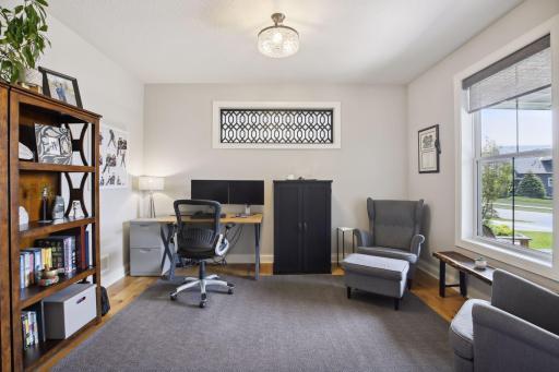 Right inside the front door is a large office space! Notice the custom window treatments!