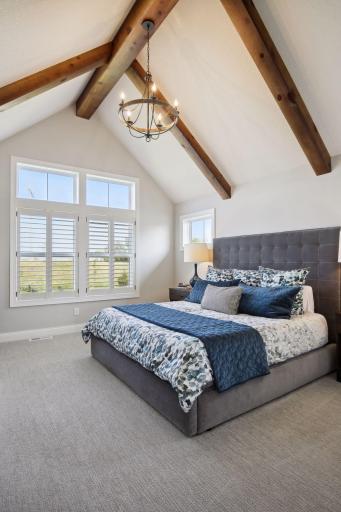 Look at your custom vaulted ceiling with beams in the master bedroom!