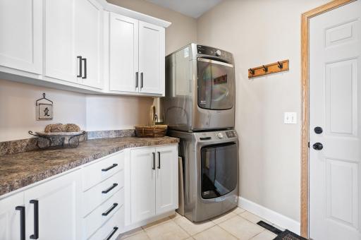 Main level laundry room where you enjoy doing laundry with all the shelving