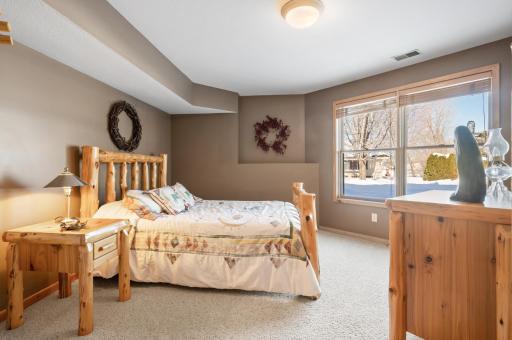 Lower level bedroom with windows letting in the natural light & warmth