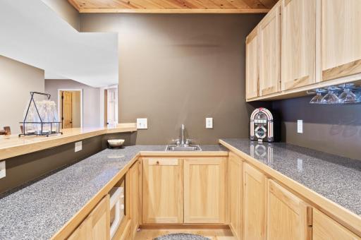 Lower level bar features sink, microwave and refrigerator