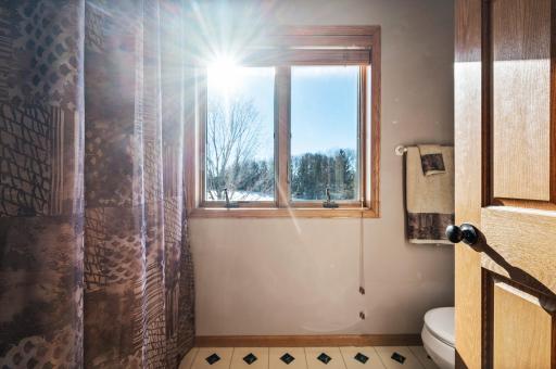 Upper level full bathroom faces front of the home
