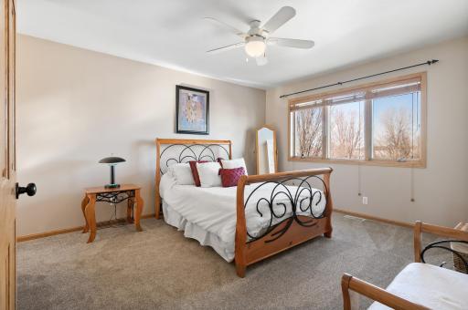Upper level bedroom #2 faces the back of the home overlooking extensively landscaped backyard