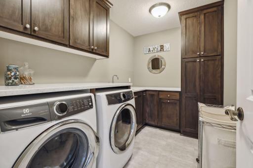Great laundry room with plenty of storage and work sink