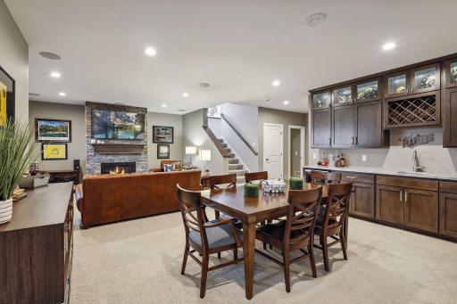 LL great room with plenty of space for games or sitting in front of the fire and watching TV. Wet bar with beverage refrigerator and storage/display