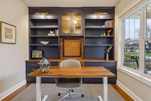 Custom office wall unit with herringbone detail and lighting
