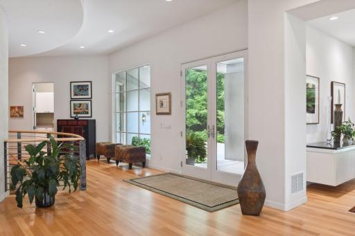 Step across the threshold into the foyer, and you will be captivated by the soft modern curves that envelop every corner of this remarkable abode.