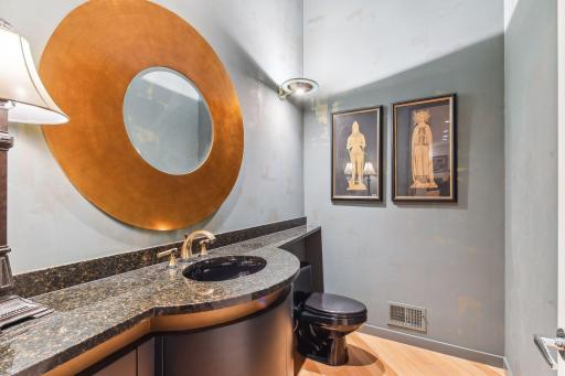 Journeying further, a main hallway unfolds, revealing a handsome powder bath.