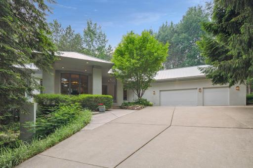 There is a three-car garage with sink, epoxy floor, and rough-in for a heater. There is a partially heated driveway, ensuring effortless access during the winter months.