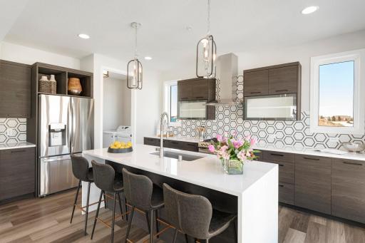 Urban inspired interiors with gourmet kitchens and luxury features. Photo is of model home; options and features will vary.