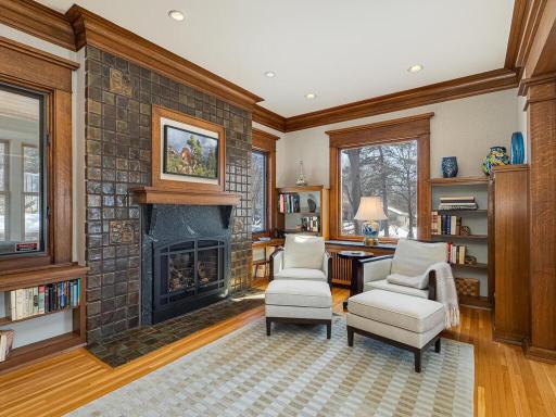 a charming Family Room/ Library with gas Fireplace, built-in bookshelves, bar, natural crow