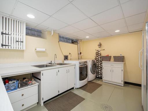 Full finished Laundry Room with folding area and storage