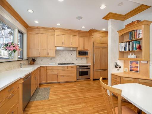 Entertaining is a pleasure with the beautifully updated Kitchen with extensive custom cabinetry, stainless steel appliances, coffee bar with vegetable sink and Corian counter tops