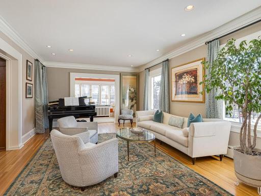 The grand sized formal Living Room with beautiful hardwood floors, high ceilings, crown moldings and large windows
