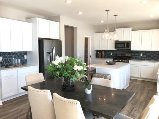 Fantastic open kitchen with ample counter space and high end included features. Finishes will vary.