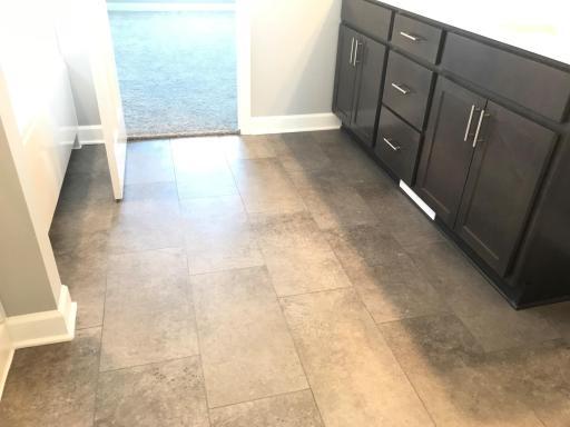 Easy clean Luxury vinyl tile and rich wood soft close cabinetry in the primary bath. Finishes will vary.