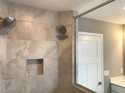 1 Another look at the walk-in shower with soap niche. Finishes will vary