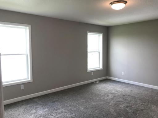 Primary bedroom with two large windows, walk-incloset, and private bath.jpg