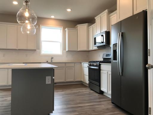 New slate appliances, quartz counter tops, walk-in pantry and awesome lighting package.jpg