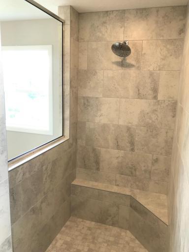 Primary bath with unbelievable walk-in shower. Tile seat, walls and floors, so nice!.jpg