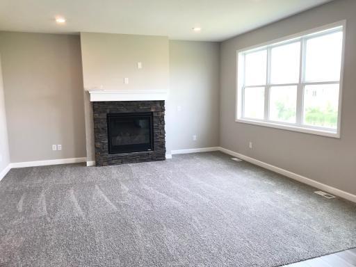 Quality Heat and Glo stone gas fireplace in the main level family room.jpg