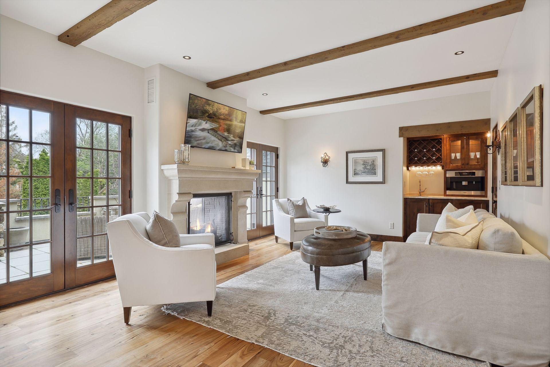 Sitting area in master suite with fireplace, espresso machine, beverage fridge and sink.