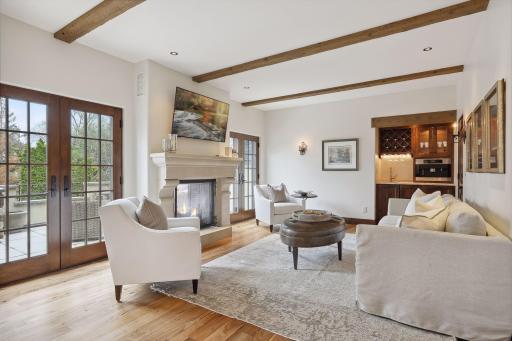 Sitting area in master suite with fireplace, espresso machine, beverage fridge and sink.