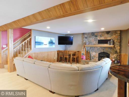 Lower level family room with wood burning fireplace.