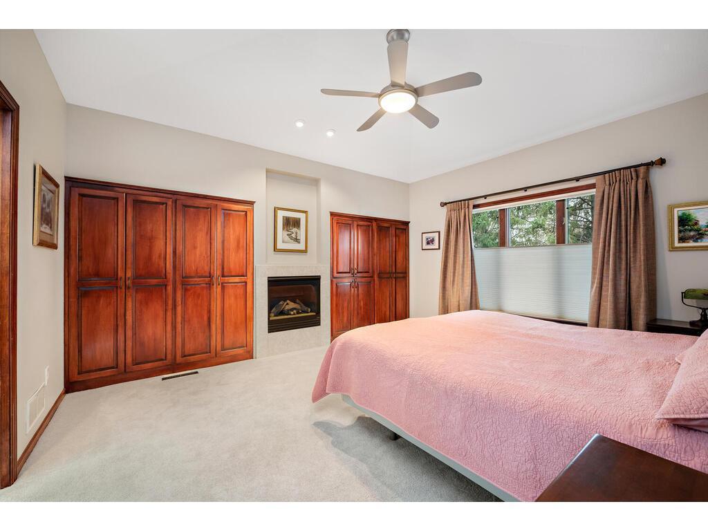 Primary bedroom with gas fireplace and ample closet space