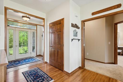 The front entry way is light and bright with the glass front door, sidelight and transom windows. The ceramic tile flooring upon entry transitions beautifully to solid oak.