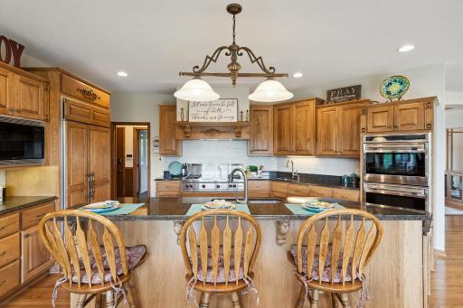 Here is your dream kitchen! It features top end appliances, custom solid hickory cabinets, Cambria counter tops, lots of lighting everywhere, two sinks with touchless Kohler faucets and a subway tile back splash.