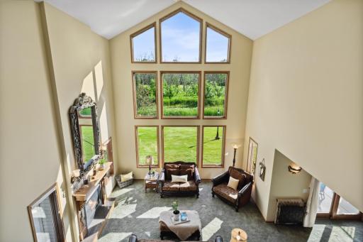 Looking over the solid oak railing to the family room area. This home has so many WOW factors, but this one might be the main one.