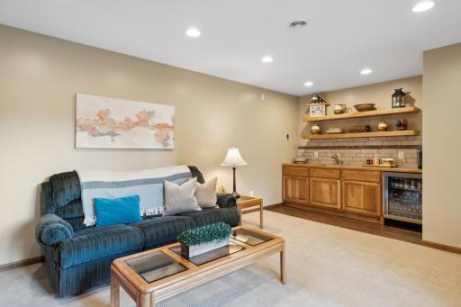 The lower level media room features a beautiful wet bar, recessed lighting and neutral paint & carpet.