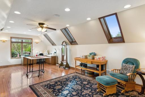 This bonus room is above the garage, and features hardwood floors and SO MUCH natural light through the skylights. And if that's not enough light, look at all those can lights!