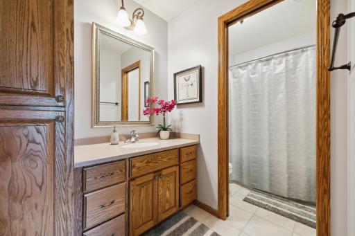 The full bath has solid oak cabinetry, tile flooring, and a Corian one piece counter top/sink combo.