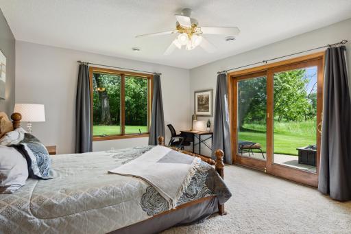 This lower level bedroom has a ceiling fan, and a walkout to a private patio!