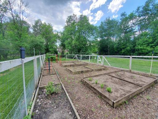 Garden beds are fenced in to keep unwanted critters out.
