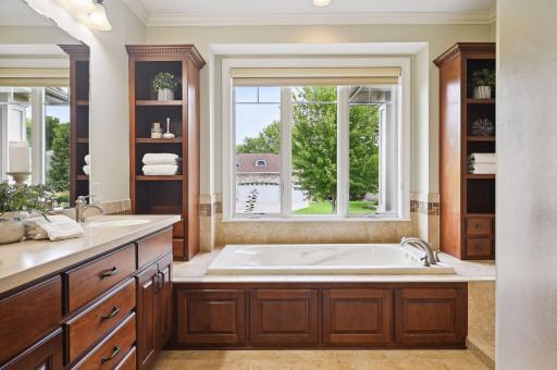 Primary suite bath with separate walk-in shower and private stool.jpg