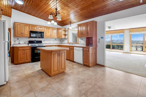 Kitchen has vaulted ceilings and a pass through window to the living room