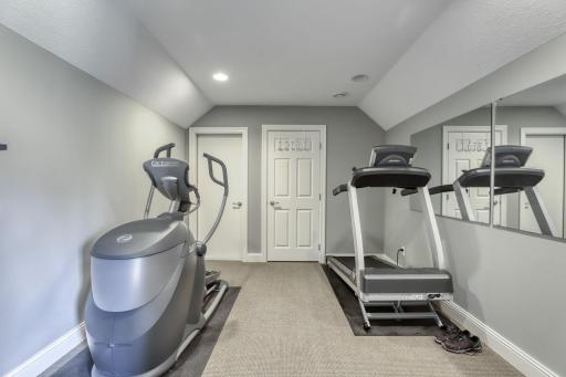 Primary bedroom exercise area that could also serve as a 2nd closet. There is a storage area beyond.